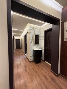 a hallway with a bathroom with a sink and a mirror at Modern 4BR 3Bath Stylish Spacious in Madinaty