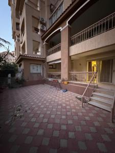 an empty courtyard of an apartment building with stairs at Modern 4BR 3Bath Stylish Spacious in Madinaty