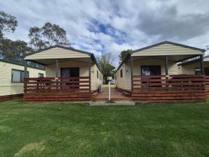 two mobile homes with large gazebos in a yard at Bonnie Doon Caravan Park in Bonnie Doon