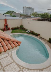 a swimming pool with a chair next to a building at Casa Vallenata boutique in Valledupar +22 photos