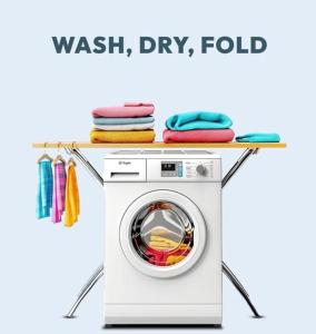 a washing machine with towels on top of it at Adi Residences - Private Apartments and Villa Stay Batticaloa in Batticaloa