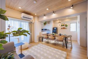 a dining room and living room with a table and chairs at Minato Marine Stay in Nagoya