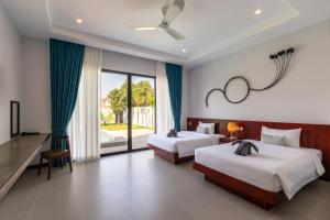a bedroom with two beds and a large window at Blanc Smith Private Villa in Siem Reap +57 photos