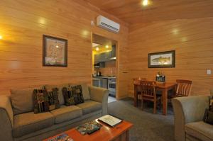 a living room with a couch and a table at Creel Lodge in Turangi