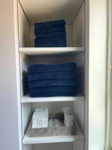 a towel rack with blue towels in a bathroom at Yuimaru - Vacation STAY 43049v in Bora