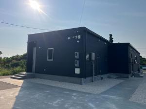 a black building with the sun shining on it at Yuimaru - Vacation STAY 43049v in Bora