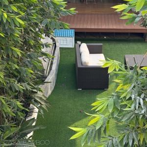 a garden with a couch on the grass at Casa Bamboo in Mexico City