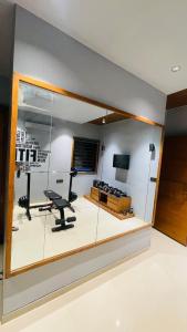 a room with a large glass wall with a gym at Nisarg’s stays in Ahmedabad +115 photos
