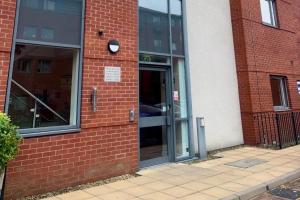 an entrance to a brick building with a revolving door at Peaceful Urban Retreat in Wolverhampton city in Wolverhampton