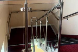 a staircase in a bus with a glass railing at Peaceful Urban Retreat in Wolverhampton city in Wolverhampton