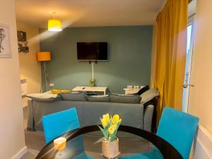 a living room with a couch and a table and chairs at Peaceful Urban Retreat in Wolverhampton city in Wolverhampton