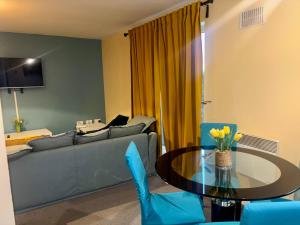 a living room with a couch and a table at Peaceful Urban Retreat in Wolverhampton city in Wolverhampton +23 photos