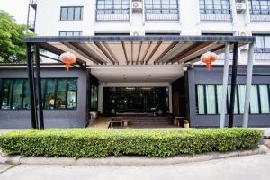 a building with two orange lanterns on top of it at Tamsabai hotel in Nakhon Sawan