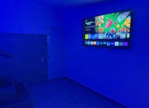 a room with a tv in a blue room at Costa Relax - 5 in Arroyo