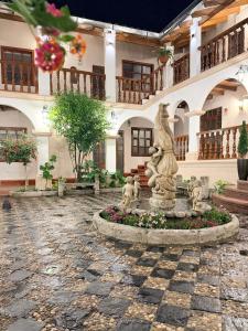 a fountain in the courtyard of a building at Posada Del Corregidor in Cajamarca