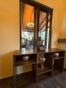 a wooden table with a statue sitting on top of it at Cabañas Puerta del Bosque núm 2 in Mazamitla +32 photos