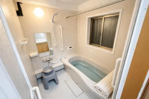 a bathroom with a bath tub and a toilet at HORIKIRI House TOKYO in Tokyo +32 photos