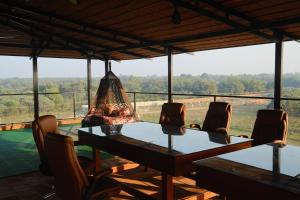 a dining room table with chairs and a chandelier at Turiya Retreat in Auroville
