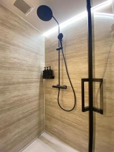 a shower with a shower head in a bathroom at Kuro Hakuba in Hakuba +87 photos