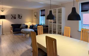 a dining room and living room with a table and chairs at Nice Home In Ansager With Wifi in Ansager