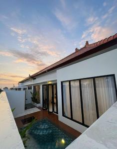 a house with a pool in front of it at Alijul Private villa in Munggu