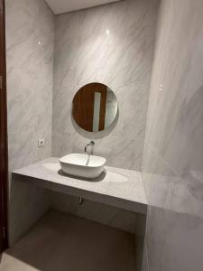 a bathroom with a sink and a mirror on a counter at Alijul Private villa in Munggu