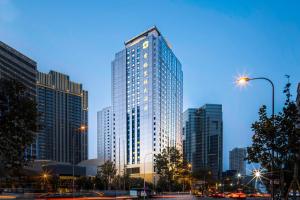 a tall building in a city at night at Shangri-La Dalian in Dalian