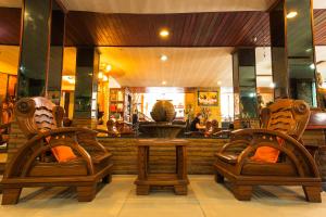 two chairs and a table in front of a restaurant at Sathorn Garden View in Bangkok +2 photos