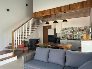 a living room and kitchen with a couch and a table at Lisa House Phu Quoc in Phú Quốc