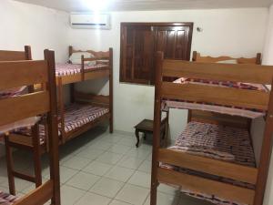 a room with several bunk beds in a room at Hostel Manga Rosa Stm in Santarém