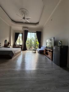 a large bedroom with a bed and a ceiling fan at THHomestay in Danang