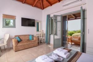 a living room with a couch and a table at The Windmill Resort in Mitáta
