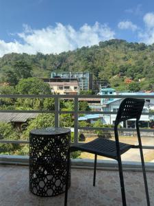 a black chair sitting on top of a balcony at Top Residence Patong in Patong Beach