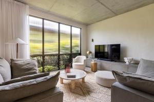 a living room with two couches and a tv at Villa Alcorn in Suffolk Park
