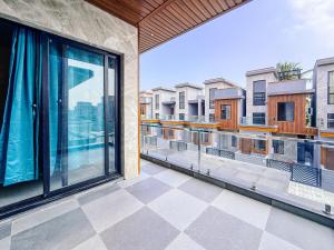 a balcony with large windows and a view of buildings at SeaLara Resorts in Covelong