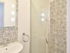 a bathroom with a shower and a sink at Anchor's Away in Filey +2 photos
