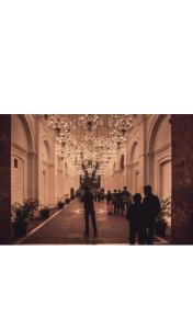 a group of people walking down a hallway in a building at Aastha view inn in Amritsar