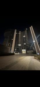 a large building is lit up at night at Fully Furnished Hotel Studio for Rent in ZED Towers Sheikh Zayed in Sheikh Zayed