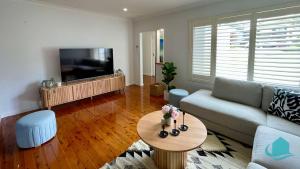 a living room with a couch and a table at Casa Calvi - Central location with Pool in Jewells Station