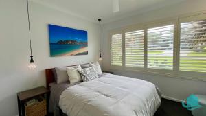 a bedroom with a bed and a large window at Casa Calvi - Central location with Pool in Jewells Station +12 photos