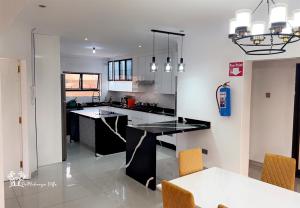 a kitchen with black and white counters and a table at Holiday Villa Marondera in Marondera