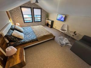 a bedroom with a large bed and a tv at Delight House in Samokov