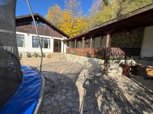 a patio with a table and a bench in front of a building at Delight House in Samokov