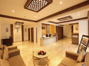 a large living room with a couch and a table at Hotel Salkara Chavakkad in Manattala