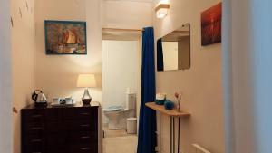 a bathroom with a toilet and a dresser and a mirror at Logis des Lauriers Roses in Marennes +47 photos