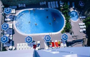 an overhead view of a large swimming pool with people in it at Arte Annapolis Inn in Rhodes Town