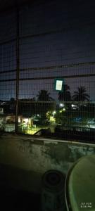 a fence in front of a parking lot at night at Kurnool Homestay in Kurnool +5 photos