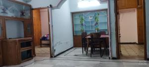 a dining room with a table and some chairs at Kurnool Homestay in Kurnool