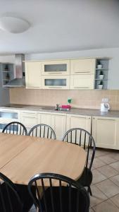 a kitchen with a wooden table and chairs at Ubytování Mája in Třeboň