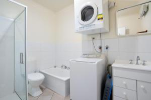 a white bathroom with a toilet and a sink at Pet Friendly Island Garden Retreat in Cowes in Cowes +13 photos